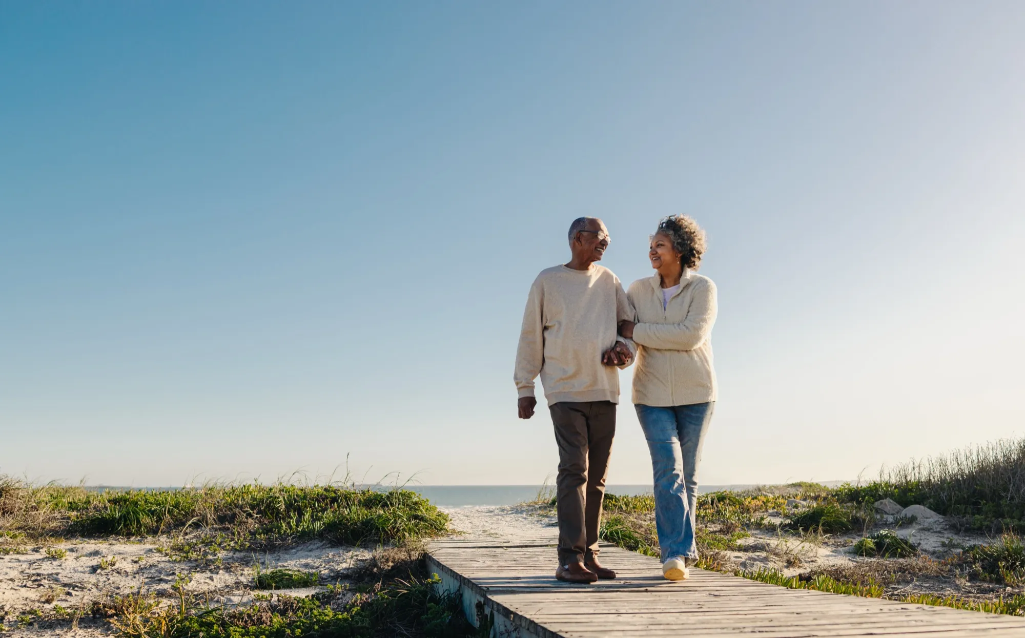 A senior walking safely outdoors with support in Grand Traverse County