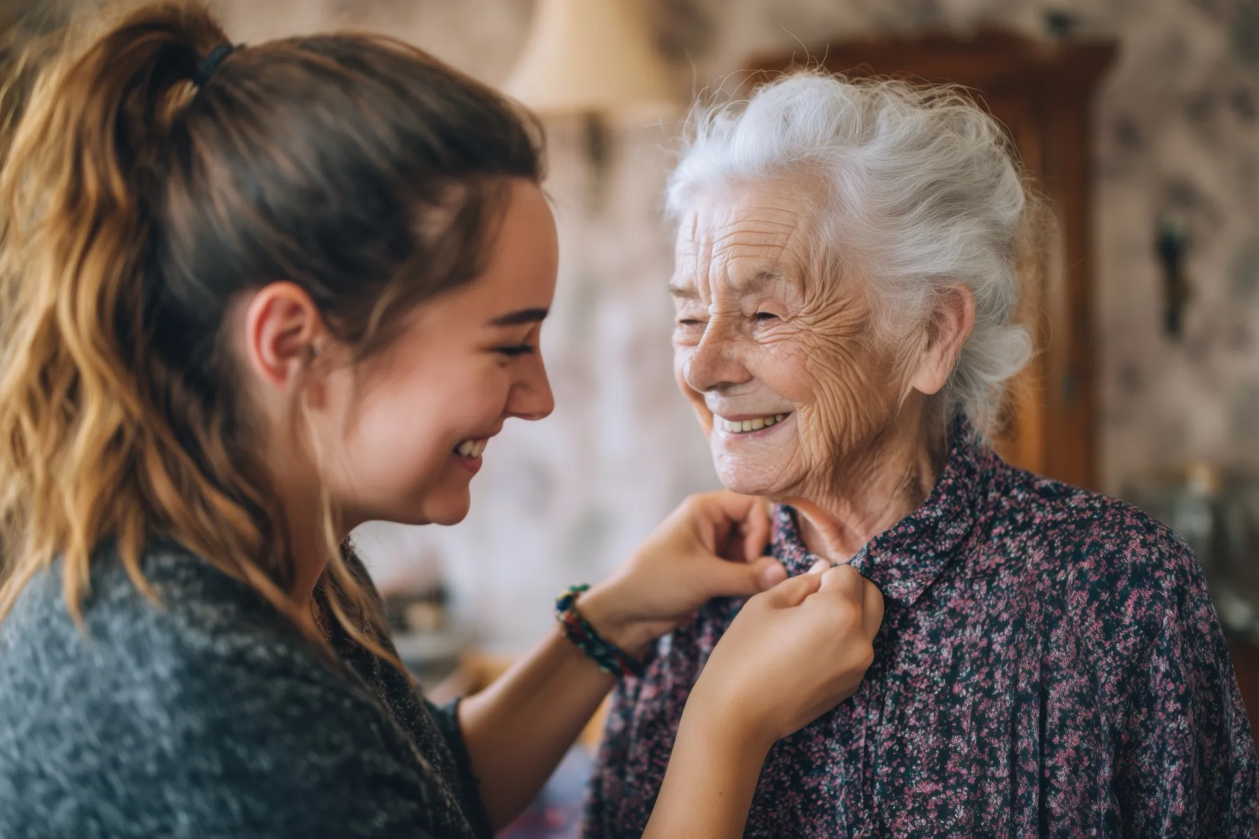 A caregiver helping a Northern Michigan senior get dressed with dignity